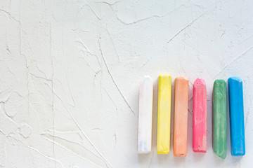 baby colored crayons on white background with copy space