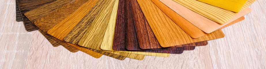 Lamination samples. On a wooden background for lamination of any wooden and plastic products used in construction.