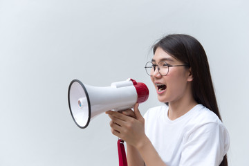 Beautiful asian woman with speaker in hand on white background,angry woman concept,Thailand people