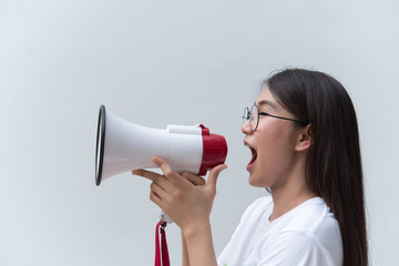 Beautiful asian woman with speaker in hand on white background,angry woman concept,Thailand people