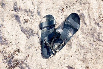 Fototapeta premium Sandals on the Beach Sand