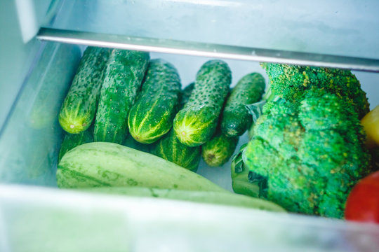 Fresh vegetables, tomatoes, peppers, cucumbers, broccoli, squash, zucchini in the refrigerator drawer for vegetables.