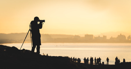 silhouette of photographer at sunset