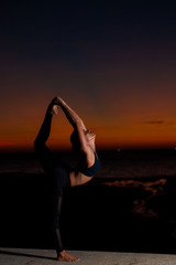 woman silhouette practicing yoga