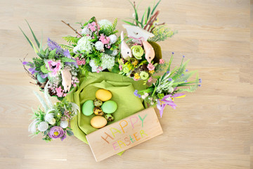 Easter eggs with spring flowers on table