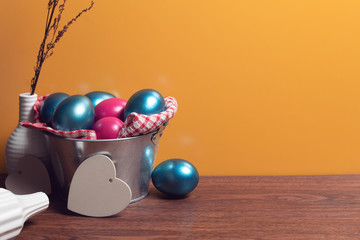 food vintage colorful easter eggs with wood vine and flower on yellow background
