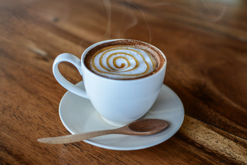 White coffee cup Placed on the wood floor, Fragrant coffee aroma Invited to feel like drinking,