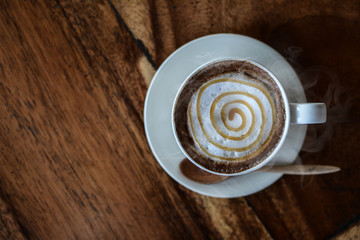 White coffee cup Placed on the wood floor, Fragrant coffee aroma Invited to feel like drinking,