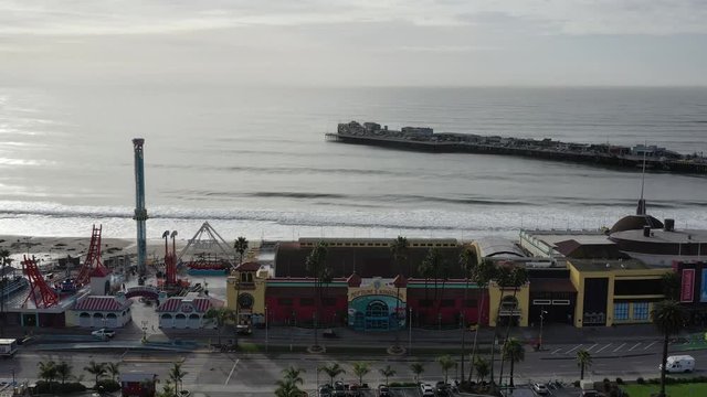 4K Aerial view of the Santa Cruz pier rollercoaster California USA. Longest wooden pier in the USA.