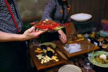 Delicious cold dish with vegetables and fish, garnished with a quail egg, served with liquid nitrogen in the restaurant. Waiters deliver food to guest tables in restaurant
