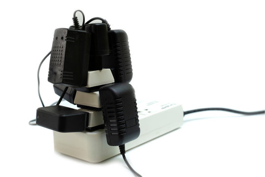 Multiple socket with connected power Strip with a bunch of plugs and adapter on white background