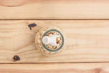 Obraz na płótnie Canvas Soybean in bottle on wood background.