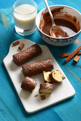 delicious chocolate, milk and cinnamon sweets with ingredients around