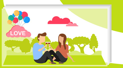 Obraz na płótnie Canvas A loving couple is sitting on a background of green nature. A man and a woman are sitting on the grass and drinking wine from their glasses.