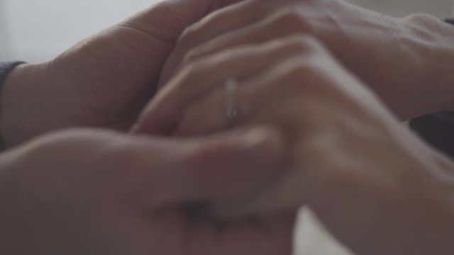 Close up of hands of a mature couple. Family relationships.