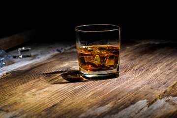 Isolated shot of whiskey with splash on black background