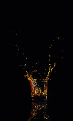 Isolated shot of whiskey with splash on black background