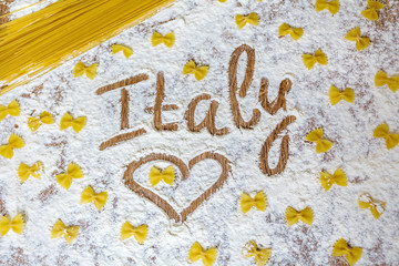 Italy  word written on table composition with flour and pasta .Love Pasta Concept 