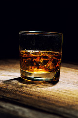 Isolated shot of whiskey on wooden background