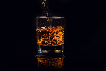 Isolated shot of whiskey on wooden background