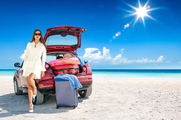 Slim young woman and red summer car on beach. Free space for your decoration. 