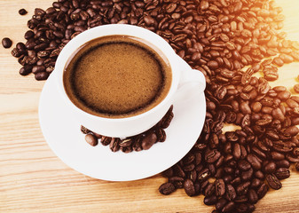 Cup of coffee and roasted coffee beans