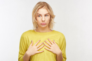 Breast augmentation concept, small size. Upset young woman with a displeased facial expression...