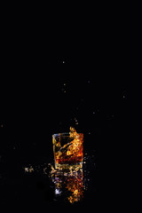 Isolated shot of whiskey with splash on black background