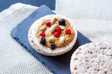 Rice crisps with peanut butter, berries and peanuts.