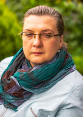 Middle-aged woman with glasses resting