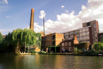 Old refurbished factory on a sunny day - obrazy, fototapety, plakaty