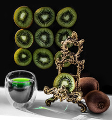 kiwi and juice in glass on Black background