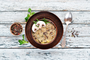 Banosh with mushrooms and bacon. Ukrainian cuisine. Top view. Free space for your text. Rustic style.