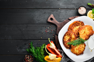 Potato pancakes with sour cream. Ukrainian Traditional Cuisine. Top view. Free space for your text. Rustic style.