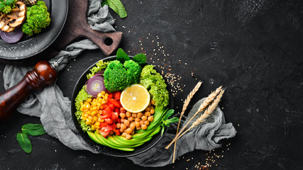 Obraz na płótnie Canvas Healthy vegetarian food. Bowl Buddha. Avocados, broccoli, turkey peas, corn. Top view. Free space for your text.