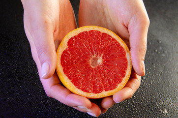 grapefruit in woman hands