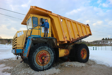 Young boy on the big yellow dump truck 