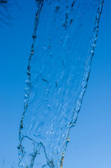Naklejka na ściany i meble transparent falling water vertical flows, close up