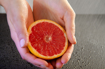 grapefruit in woman hands