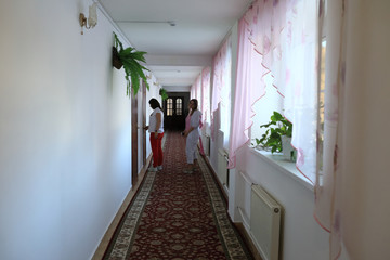 Two women in hotel corridor