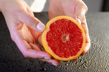 grapefruit in hands