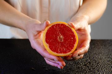 grapefruit in female hands