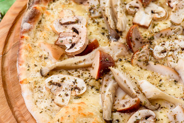 Italian Vegetarian Mushroom Pizza with  cheddar on a round wooden board on a red wooden background, decorated with napkins, chili pepper and cherry tomatoes. close up