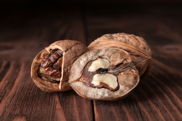 Walnut on rustic table. Slice of walnut on wooden. Kernels walnut. Background of walnuts. Healthy walnuts. Fresh walnuts