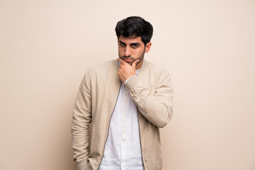 Fototapeta premium Young man over isolated wall thinking