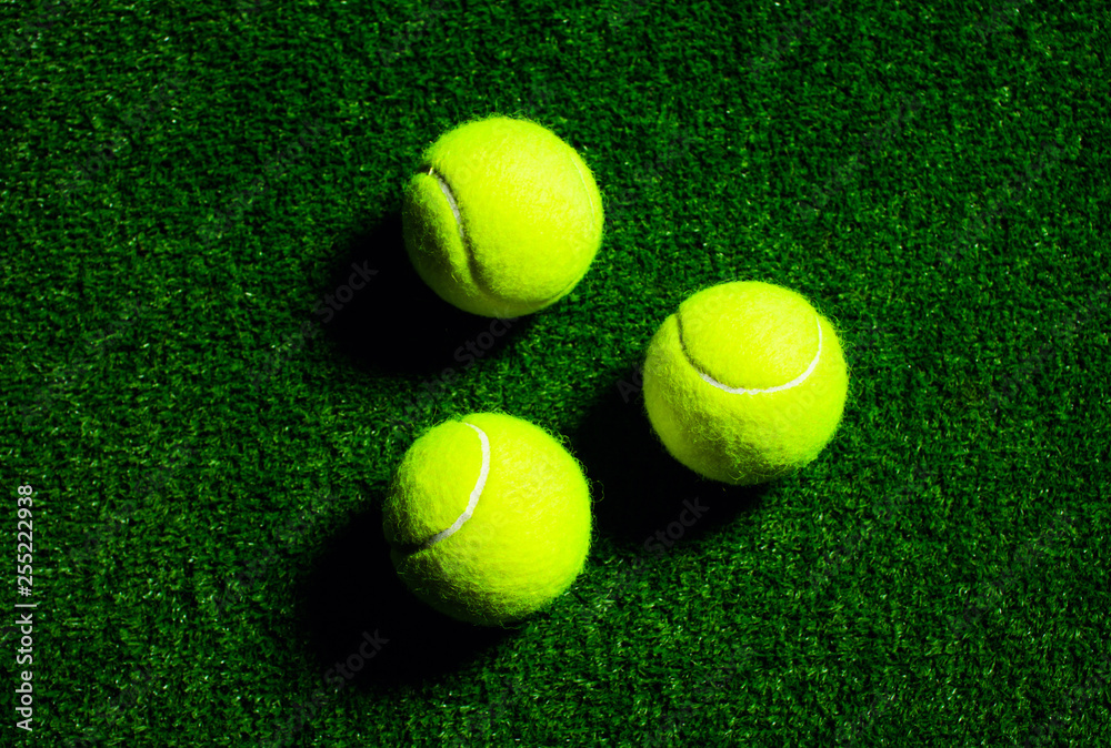 Wall mural Tennis Ball isolated on black with dramatic lighting