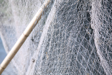 Background with fishing net and bamboo stick