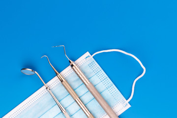 Fototapeta na wymiar Dental medical tools on blue background. Top view. Dentist Concept. - Image