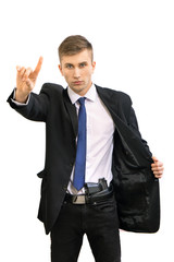 Portrait of young attractive serious security business man with gun in dark suit and bright blue tie, isolated on white
