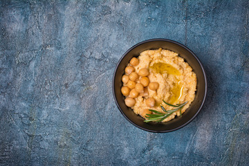 Traditional homemade chickpea hummus snack with spice of rosemary